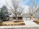 Classic two-story home with brick and siding, showcasing a two-car garage and mature landscaping at 8783 E Phillips Pl, Centennial, CO 80112