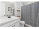 Bathroom featuring a stylish vanity, modern mirror, and a shower with a patterned curtain at 17901 E Emilia Dr, Parker, CO 80134