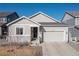 Charming single-story home with neutral siding, stone accents, and an attached two-car garage at 17901 E Emilia Dr, Parker, CO 80134