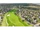 Aerial view of a home near a golf course surrounded by trees and other houses at 7120 Forest Ridge Cir, Castle Pines, CO 80108
