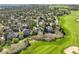 Aerial view of property showcasing the home, backyard, surrounding trees, and golf course views at 7120 Forest Ridge Cir, Castle Pines, CO 80108