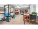Spacious finished basement with living area, kitchenette, and workout space with exercise equipment at 7120 Forest Ridge Cir, Castle Pines, CO 80108