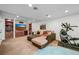 Finished basement living area featuring comfortable seating, built-in shelving and an exercise bike at 7120 Forest Ridge Cir, Castle Pines, CO 80108