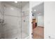 Bathroom with a glass-enclosed shower, featuring gray stone tile and modern fixtures at 7120 Forest Ridge Cir, Castle Pines, CO 80108