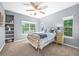 Cozy bedroom with large windows providing natural light and a ceiling fan for added comfort at 7120 Forest Ridge Cir, Castle Pines, CO 80108