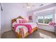 Charming bedroom featuring a window seat, plush carpeting, and warm natural light at 7120 Forest Ridge Cir, Castle Pines, CO 80108