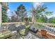 Outdoor deck with a wrought iron table, seating, a shade umbrella, and tree views at 7120 Forest Ridge Cir, Castle Pines, CO 80108