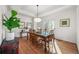 Bright dining room with tray ceilings, wood floors, and a decorative wooden dining table at 7120 Forest Ridge Cir, Castle Pines, CO 80108