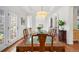 Elegant dining room with a glass-top table and ample natural light at 7120 Forest Ridge Cir, Castle Pines, CO 80108