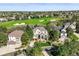 A charming two-story home near a golf course, featuring a stone facade, mature trees, and a manicured lawn at 7120 Forest Ridge Cir, Castle Pines, CO 80108