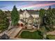 Beautiful two-story home featuring a stone facade, two-car garage, lush lawn and meticulous landscaping at 7120 Forest Ridge Cir, Castle Pines, CO 80108