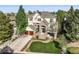 Lovely two-story home with stone accents, mature trees, and an attached two-car garage at 7120 Forest Ridge Cir, Castle Pines, CO 80108