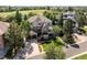 Charming home showcasing a manicured lawn, mature trees, and a convenient two-car garage at 7120 Forest Ridge Cir, Castle Pines, CO 80108