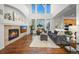 Spacious living room boasts a vaulted ceiling, fireplace, large windows, and comfortable seating at 7120 Forest Ridge Cir, Castle Pines, CO 80108