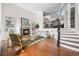 Bright living room with a fireplace, hardwood floors, and open staircase at 7120 Forest Ridge Cir, Castle Pines, CO 80108