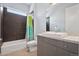 Clean bathroom featuring a granite countertop vanity and bathtub with a colorful shower curtain at 11645 Colony Loop, Parker, CO 80138