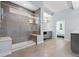 Modern bathroom showcasing a spacious glass shower, sleek tiling, and contemporary design elements at 11645 Colony Loop, Parker, CO 80138