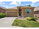 Attractive single-story home featuring a two-car garage, arched window and manicured lawn at 11645 Colony Loop, Parker, CO 80138