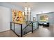 Upper hallway with glass-paneled staircase and a view into the living room at 11645 Colony Loop, Parker, CO 80138