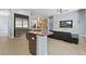 Contemporary kitchen with an island, stainless steel appliances, and open living area at 11645 Colony Loop, Parker, CO 80138
