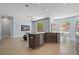 Open kitchen and living area with a kitchen island and stone countertops at 11645 Colony Loop, Parker, CO 80138