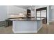 Modern kitchen island with stone countertop and stainless steel appliances at 11645 Colony Loop, Parker, CO 80138