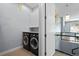 Laundry room featuring black washer and dryer and white cabinets at 11645 Colony Loop, Parker, CO 80138