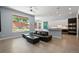 Bright living room area featuring large window and open to kitchen at 11645 Colony Loop, Parker, CO 80138