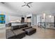 Open-concept living room boasts modern design with kitchen view and sleek black sectional sofa at 11645 Colony Loop, Parker, CO 80138
