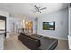 Bright living room featuring a black leather sofa, ceiling fan and large wall-mounted television at 11645 Colony Loop, Parker, CO 80138