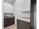 Mud room with modern gray cabinets, countertops, and tile flooring at 11645 Colony Loop, Parker, CO 80138