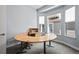 Bright office space featuring a large semi-circular desk and natural light from two windows at 11645 Colony Loop, Parker, CO 80138