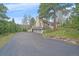 Home exterior features a three-car garage and long driveway at 787 W Meadow Rd, Evergreen, CO 80439