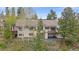 An exterior elevation of a home surrounded by trees and professional landscaping at 787 W Meadow Rd, Evergreen, CO 80439