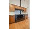 Close up of a black oven with white tile backsplash and custom cabinets in the kitchen area at 787 W Meadow Rd, Evergreen, CO 80439