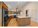 Well-equipped kitchen with wooden cabinets, a central island with sink, and modern appliances for culinary enthusiasts at 787 W Meadow Rd, Evergreen, CO 80439