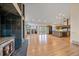 Open floor plan showcasing hardwood floors, a fireplace, and access to the kitchen and balcony at 787 W Meadow Rd, Evergreen, CO 80439