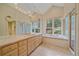 Bright main bathroom featuring double vanity, soaking tub, and a separate glass shower at 787 W Meadow Rd, Evergreen, CO 80439