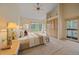 Stylishly staged main bedroom with a large window offering beautiful views and inviting natural light at 787 W Meadow Rd, Evergreen, CO 80439