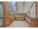 Sunny sun room with tile flooring, windows and built-in shelves at 787 W Meadow Rd, Evergreen, CO 80439