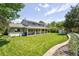 Expansive backyard featuring a manicured lawn, a garden, and a covered patio ideal for entertaining and relaxation at 3843 S Quince St, Denver, CO 80237