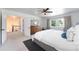 Bright bedroom featuring ceiling fan, large windows and neutral decor at 3843 S Quince St, Denver, CO 80237