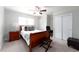 Bedroom features a ceiling fan, a large window, a cherry-wood sleigh bed, and ample closet space at 3843 S Quince St, Denver, CO 80237