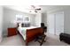 Bedroom features a ceiling fan, a large window, a cherry-wood sleigh bed, and ample closet space at 3843 S Quince St, Denver, CO 80237