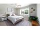 Cozy bedroom with a large window, stylish decor and ceiling fan at 3843 S Quince St, Denver, CO 80237