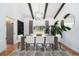 Elegant dining room with vaulted ceilings, beam accents, and modern chandelier at 3843 S Quince St, Denver, CO 80237