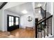 Welcoming foyer with hardwood floors, staircase, and stylish decor at 3843 S Quince St, Denver, CO 80237
