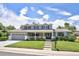 Two-story home featuring a spacious front yard, covered porch, and attached garage at 3843 S Quince St, Denver, CO 80237
