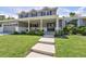 Charming two-story home with manicured lawn, covered porch, and inviting entrance at 3843 S Quince St, Denver, CO 80237