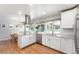 Bright and modern kitchen with stainless steel appliances, granite countertops, and white cabinetry at 3843 S Quince St, Denver, CO 80237